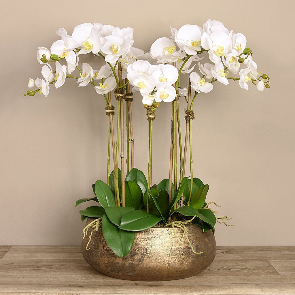 Faux white orchid arrangement in matte gold planter