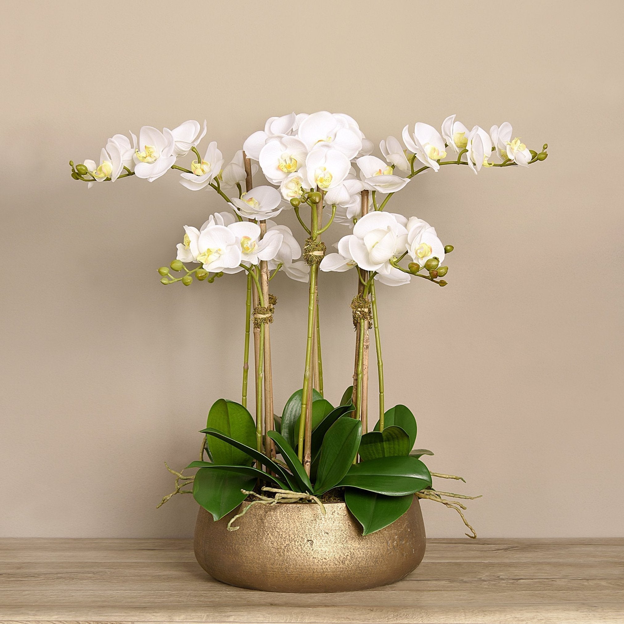 Faux white orchid arrangement in matte gold planter
