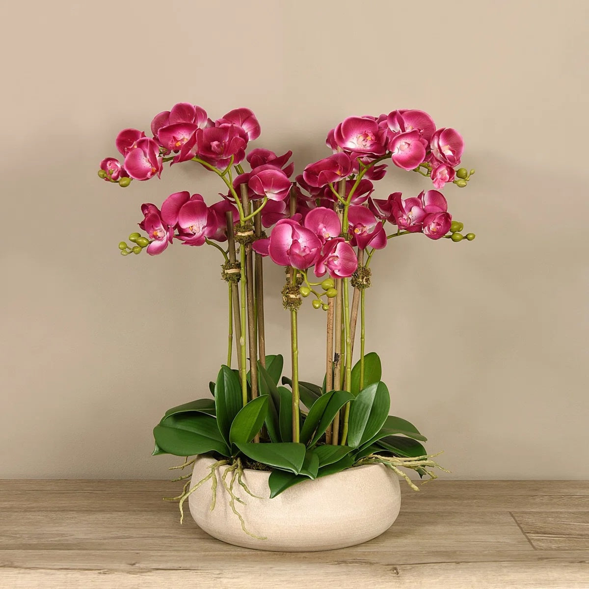 Artificial pink orchid centerpiece arrangement in beige planter