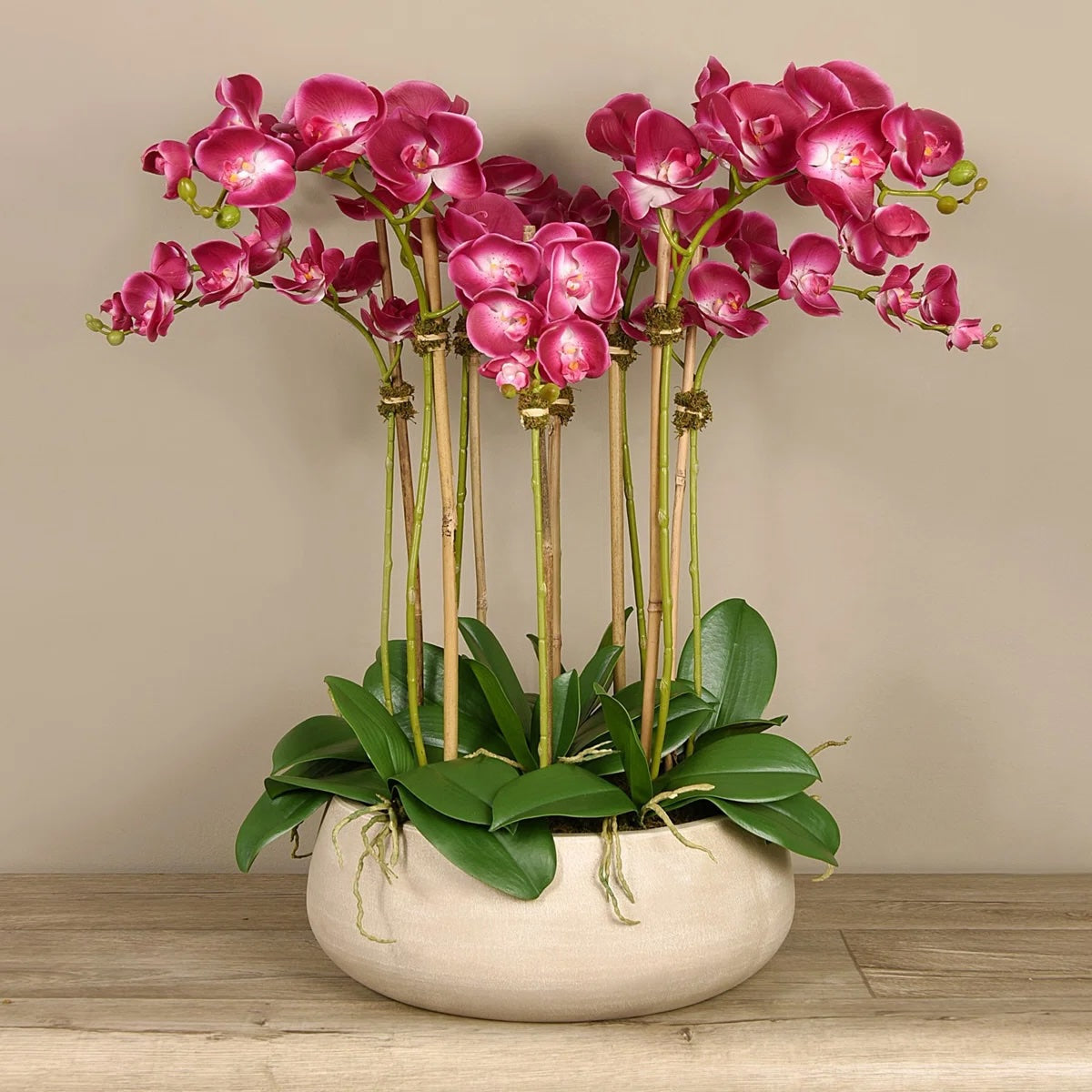 Artificial pink orchid centerpiece arrangement in beige planter